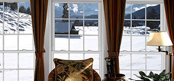 Interior bay windows overlooking snowy mountainside